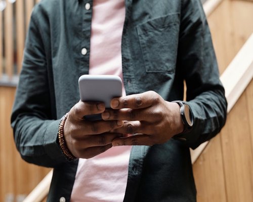 Person typing on a smartphone while walking